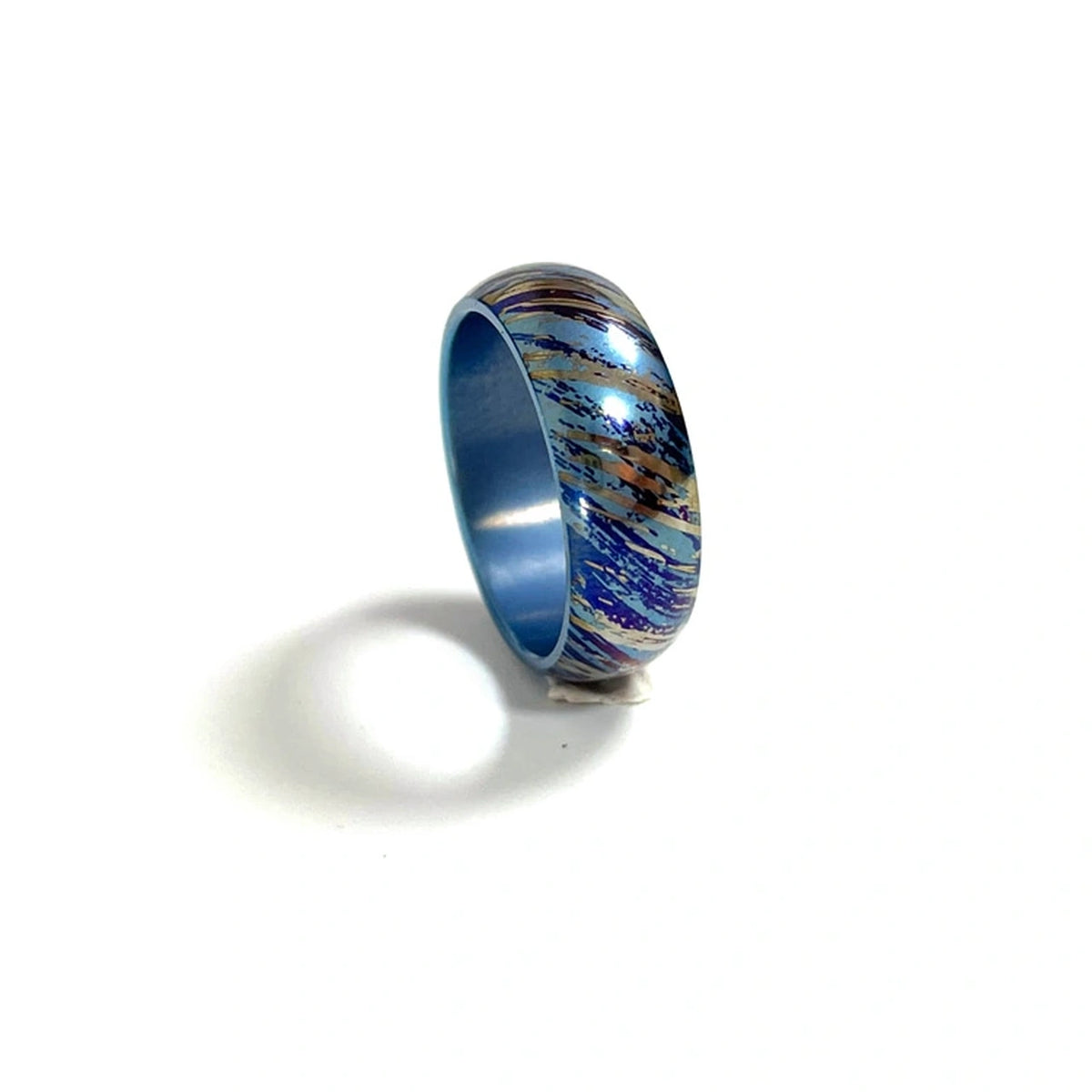 Anodized Titanium Band Ring: blue streak patterned ring on white (gallery view 08).