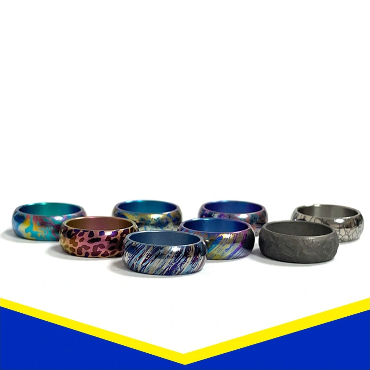 Anodized Titanium Band Ring: multiple patterned band rings arranged on white (gallery view 01).