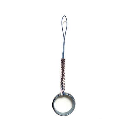 Anodized Titanium Band Ring: ring on a purple woven cord loop (gallery view 16).