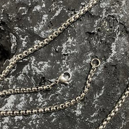Anodized Titanium Band Ring: separate stainless steel chain accessory on stone (gallery view 15).