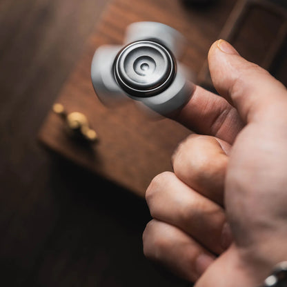 Dark River metal fidget spinner rotating between fingers