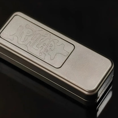 Compact steel fidget slider showing its exposed mechanism