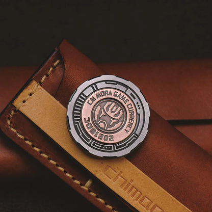 Chimago queen decision coin displayed on a leather organizer