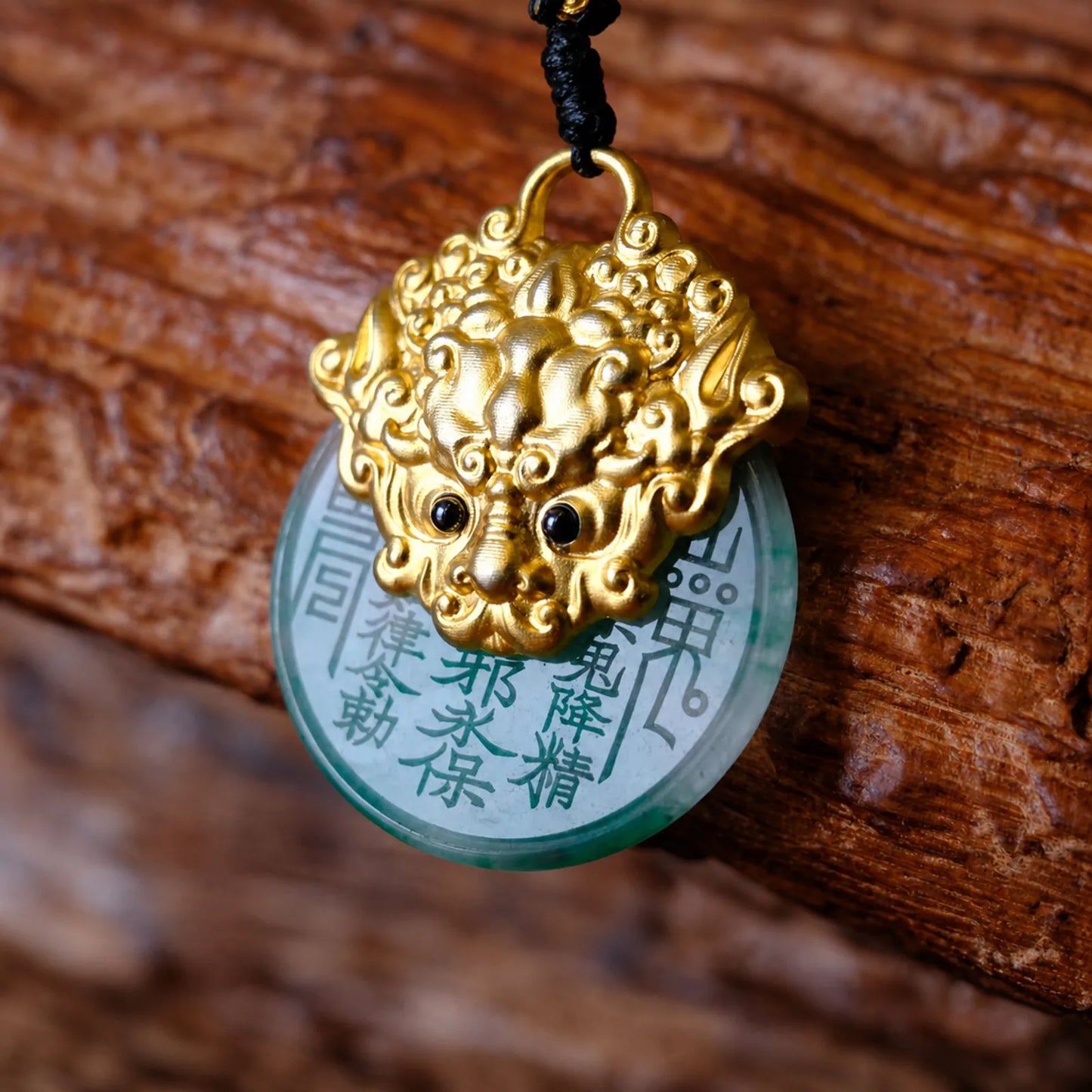 Rotating quartzite jade guardian pendant with gold tone carving