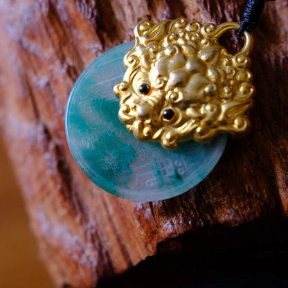 Guardian pendant showing green stone disc and sculpted metal front