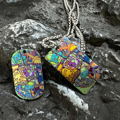 Pokemon Artwork Titanium Dog Tag: overlapping illustrated dog tag designs on stone (gallery view 03).