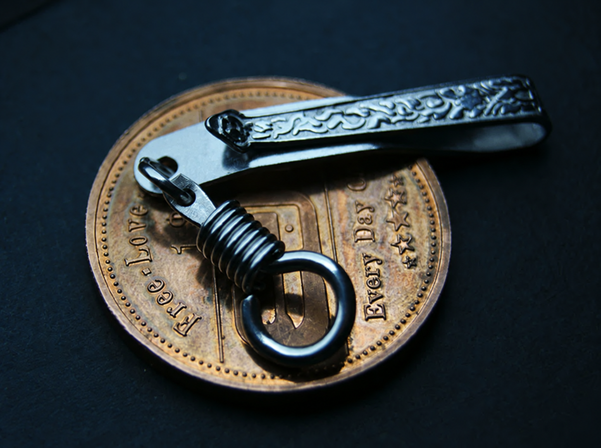 Reverse angle of the silver-tone pocket clip and its connector ring; display coin not included