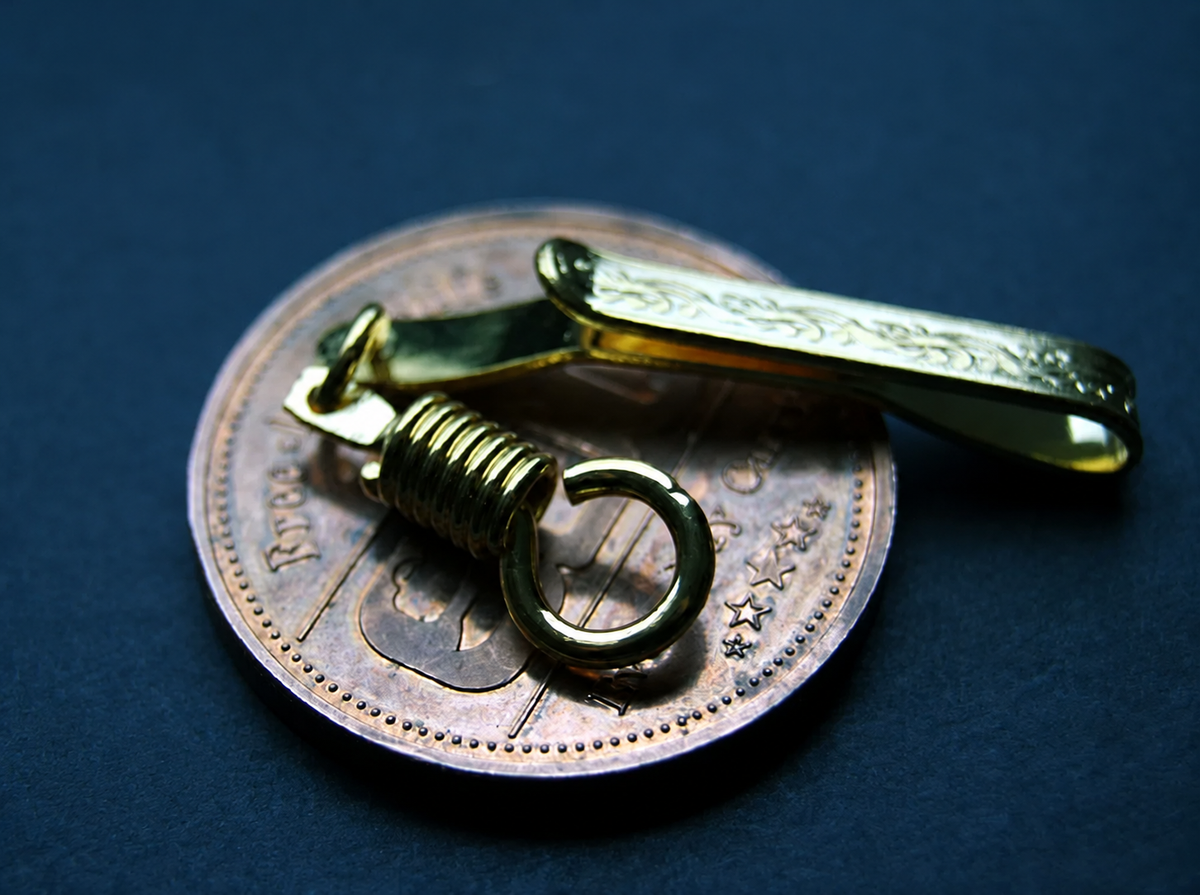 Reverse angle of the gold-tone pocket clip and its connector ring; display coin not included