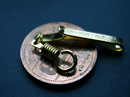 Reverse angle of the gold-tone pocket clip and its connector ring; display coin not included