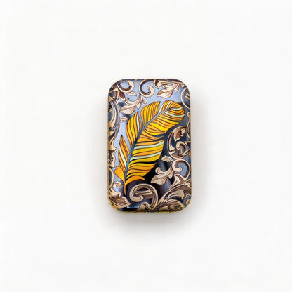 Rotating Titanium Fidget Slider: gold feather artwork on a dark rectangular face (gallery view 04).