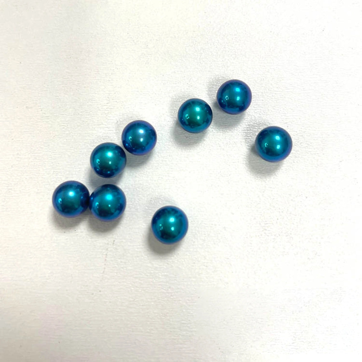 Titanium Spinner Balls: second peacock blue ball grouping on white (gallery view 13).