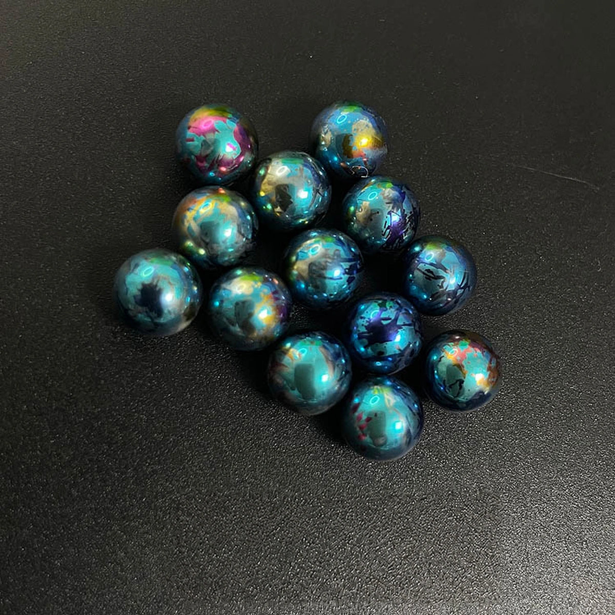 Titanium Spinner Balls: splatter peacock blue balls against black (gallery view 21).