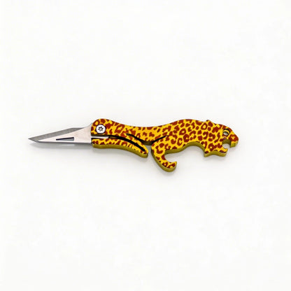 Animal-Shaped Titanium Folding Knife & Bottle Opener: leopard handle with blade extended on white (gallery view 03).