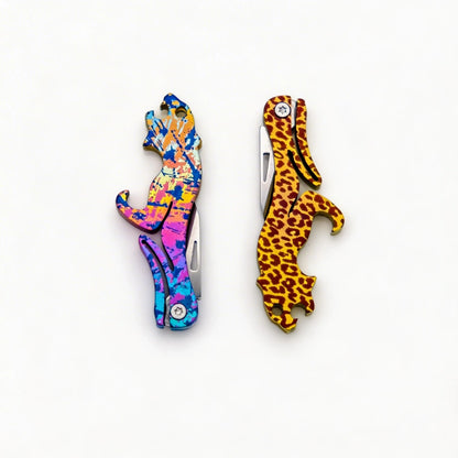 Animal-Shaped Titanium Folding Knife & Bottle Opener: splatter and leopard handles folded side by side (gallery view 01).