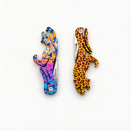 Animal-Shaped Titanium Folding Knife & Bottle Opener: splatter and leopard handles folded side by side (gallery view 01).