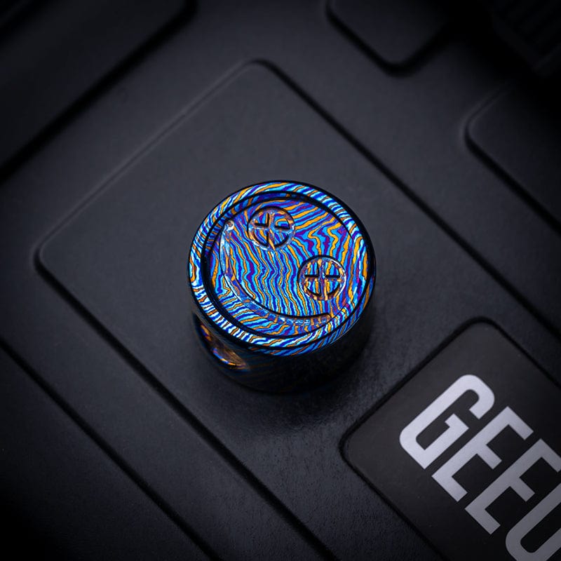 EDC Lanyard Bead – Bad Guy Smile | Titanium Zirconium Damascus Mokuti Super Conductor