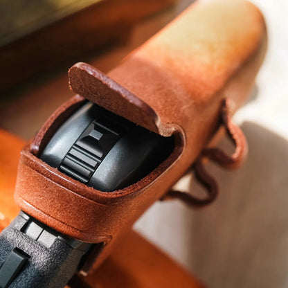 Brown leather case shown fitted around a Ring-Frame toy