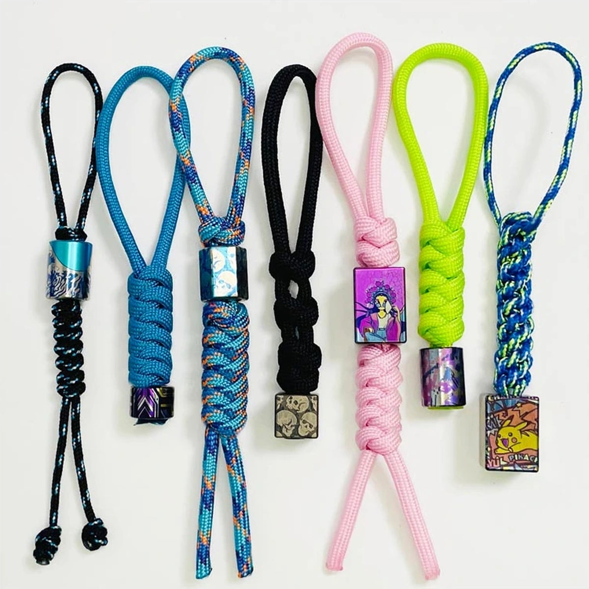 Nine-Star TC4 Titanium Lanyard Bead: assorted handwoven cord configurations shown together (gallery view 11).