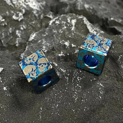Green & Blue Skull Titanium Lanyard Beads: blue square skull beads showing center openings (gallery view 04).
