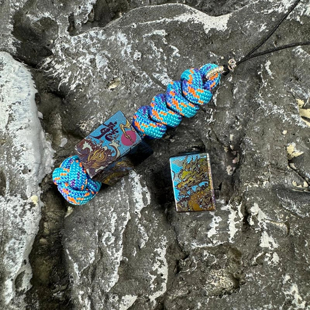 Wave Dragon Titanium Lanyard Bead: dragon bead lanyard beside loose bead (gallery view 04).