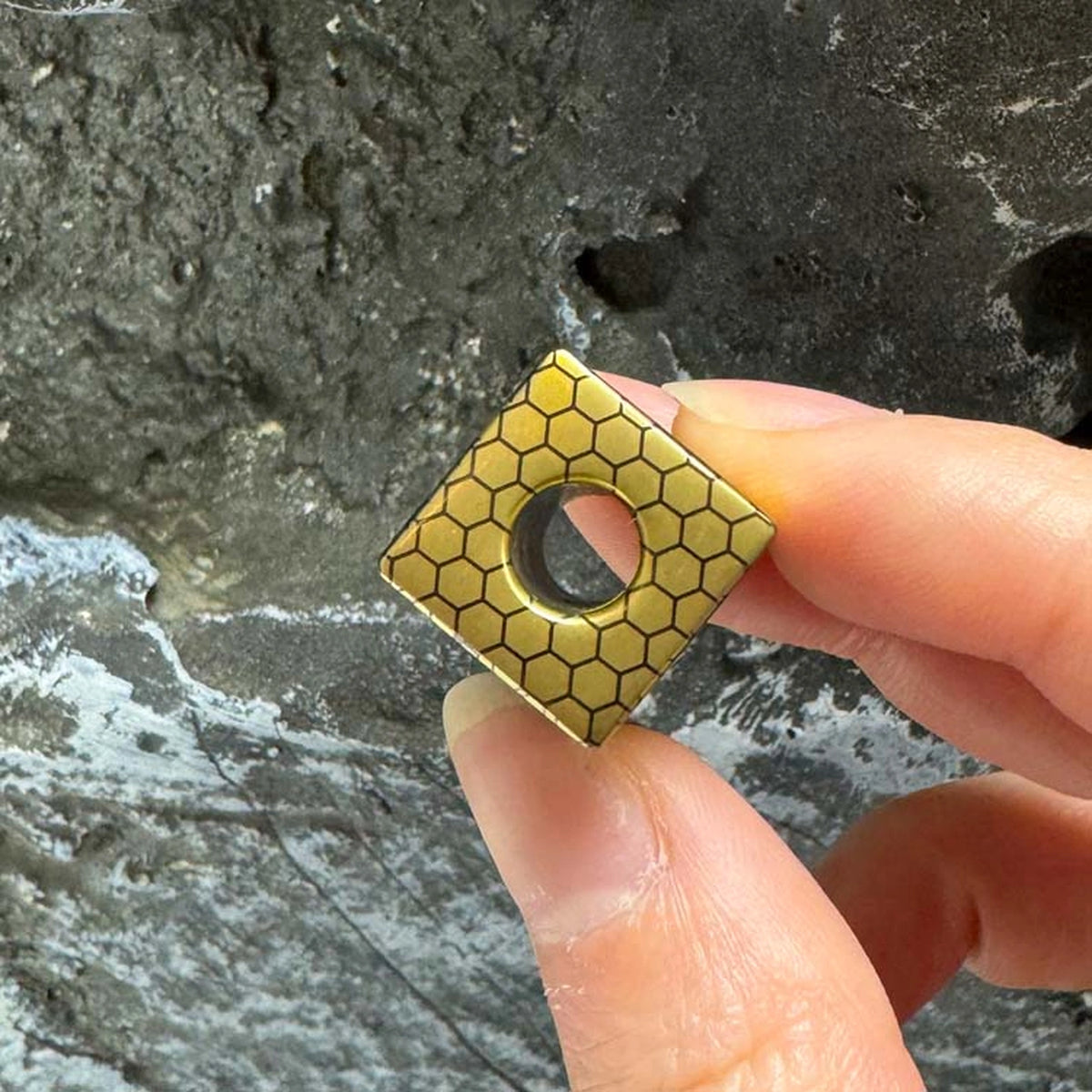 Bee Emperor Titanium Lanyard Bead: hand-held top view showing center opening (gallery view 03).