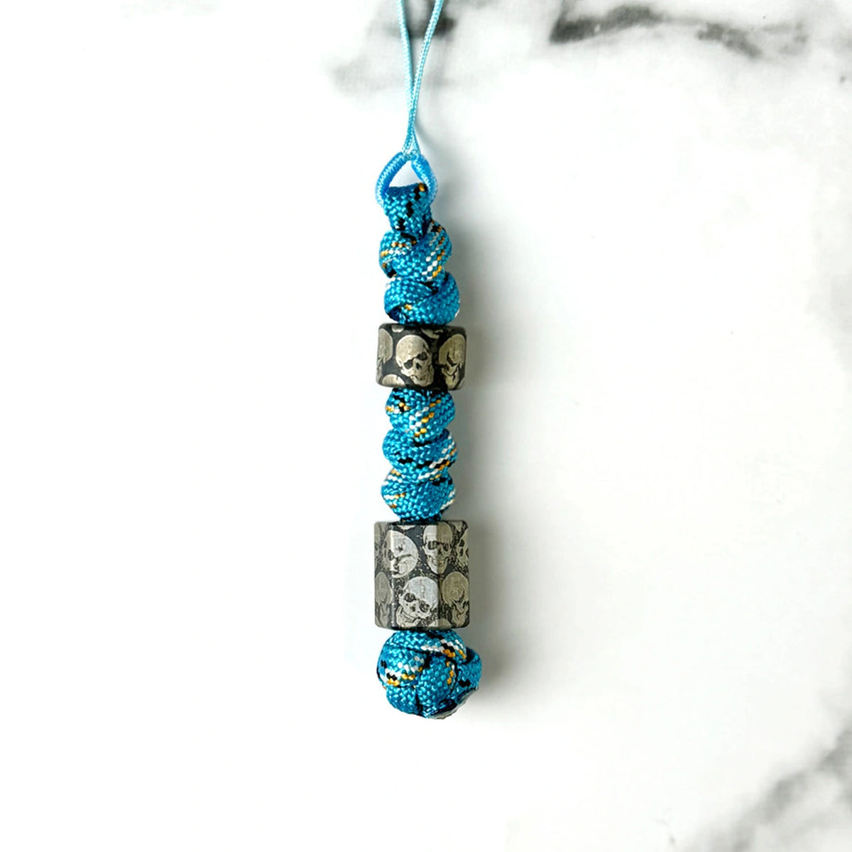 Dark Skull Titanium Lanyard Beads: round and hexagonal skull beads on blue cord (gallery view 19).