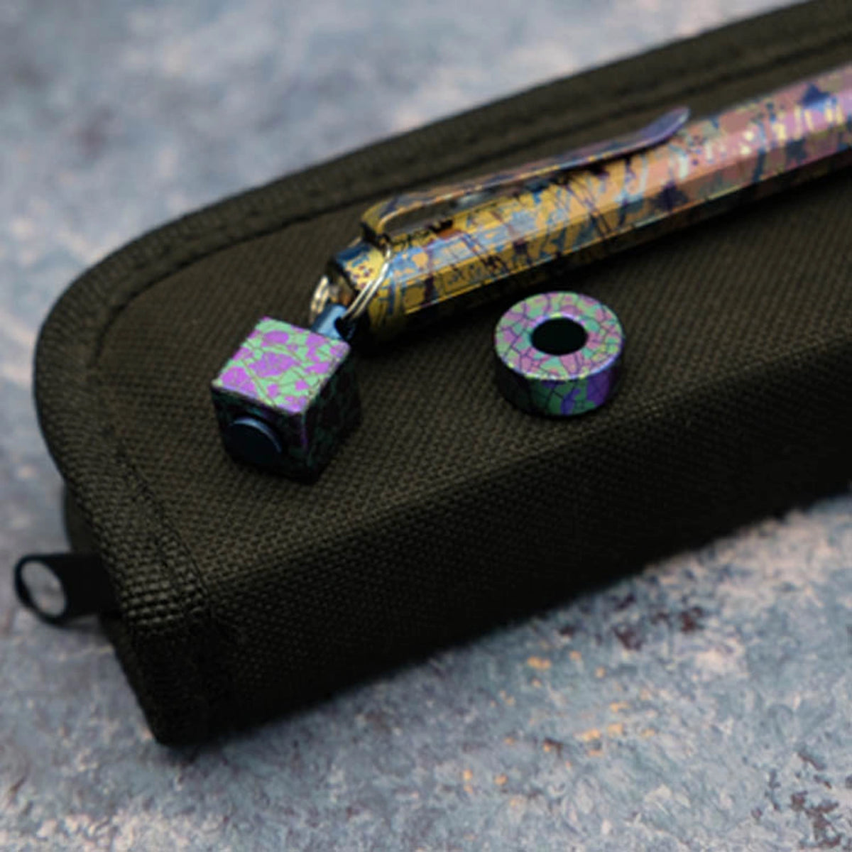 Camouflage Titanium Lanyard Beads: round and square beads beside a case prop (gallery view 03).
