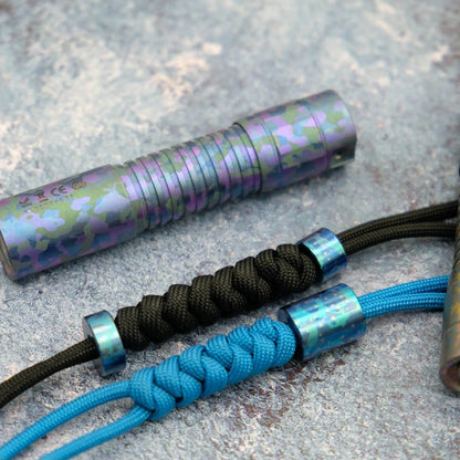 Starry Sky Titanium Lanyard Bead: round beads fitted to black and blue cords (gallery view 03).