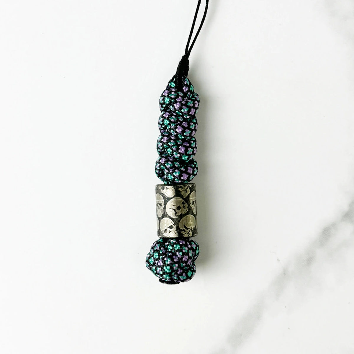 Dark Skull Titanium Lanyard Beads: round skull bead on dark patterned cord (gallery view 11).