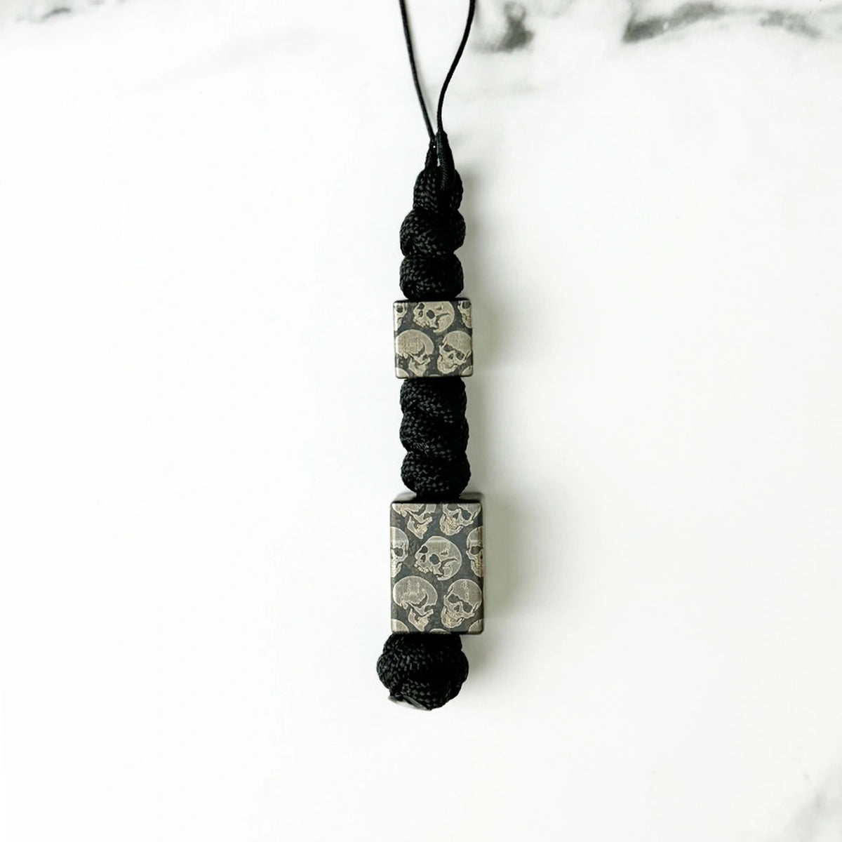 Dark Skull Titanium Lanyard Beads: small and large round skull beads on black cord (gallery view 16).