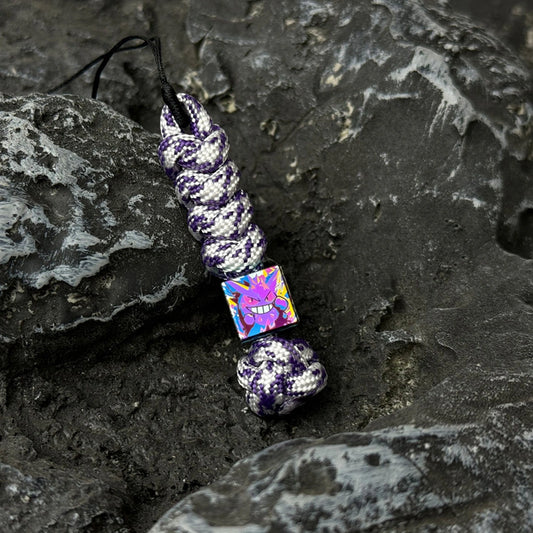Gengar Artwork Titanium Lanyard Beads: small character bead on purple woven cord (gallery view 01).