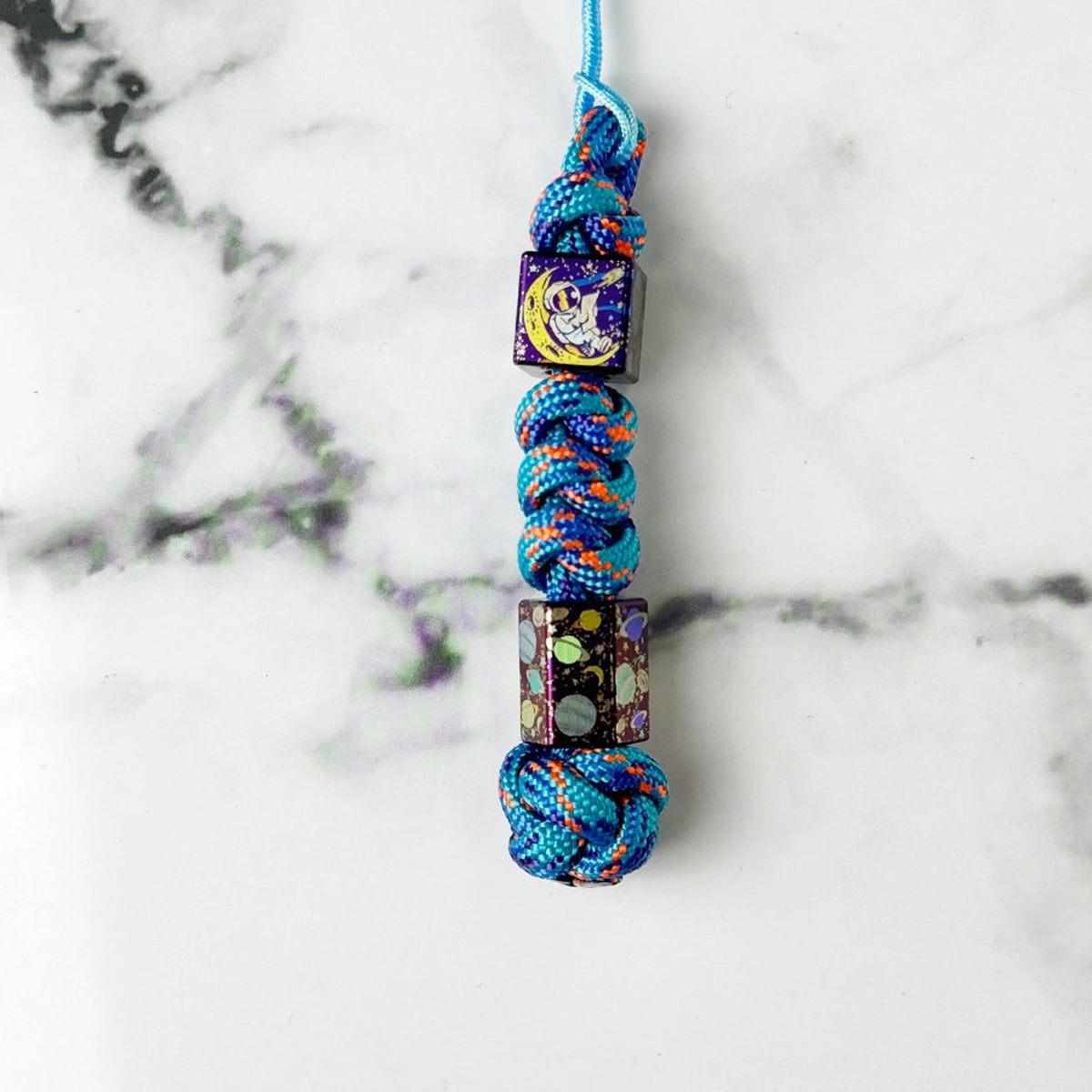 Planet Artwork Titanium Lanyard Beads: small square and hexagonal beads on blue cord (gallery view 17).