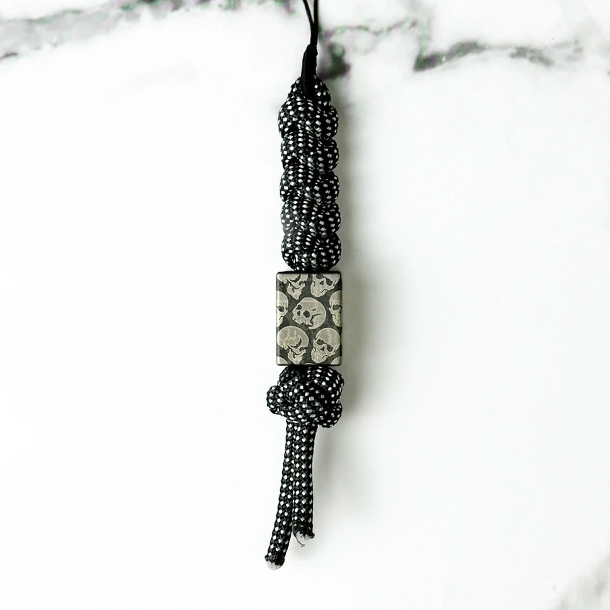 Dark Skull Titanium Lanyard Beads: small square skull bead on black patterned cord (gallery view 13).