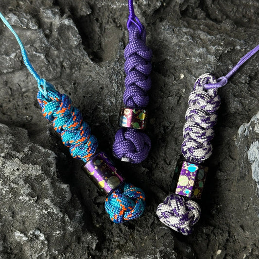 Planet Artwork Titanium Lanyard Beads: three planet bead lanyards on stone (gallery view 01).