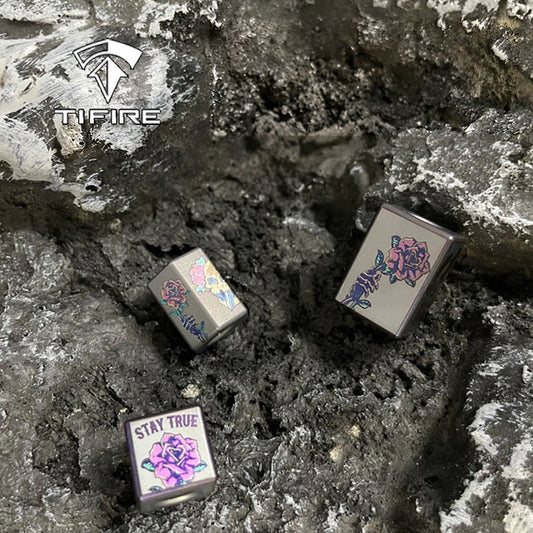 Rose Skull Titanium Lanyard Bead: three rose skull bead shapes on stone (gallery view 01).