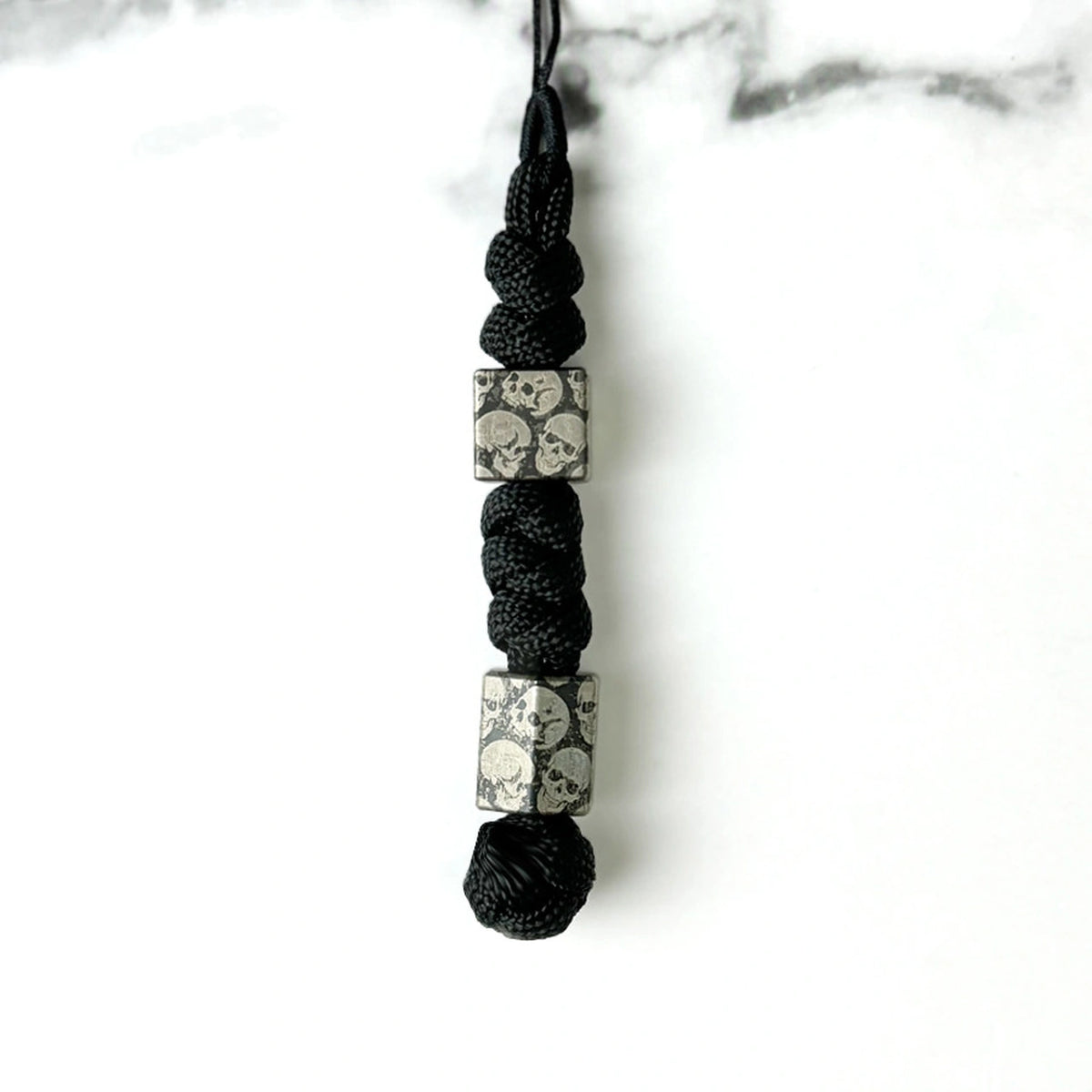 Dark Skull Titanium Lanyard Beads: two square skull beads on black cord (gallery view 17).