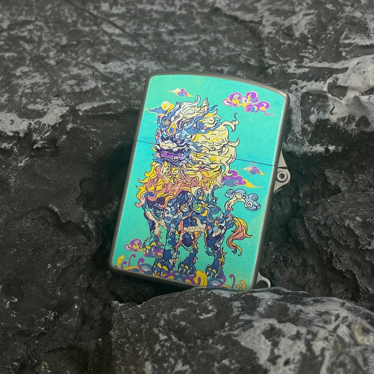 Titanium Wick Lighter: qilin artwork face resting on stone (gallery view 04).