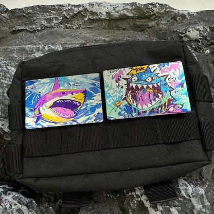 Illustrated Titanium Morale Patch: two shark patches displayed on a black patch panel (gallery view 03).