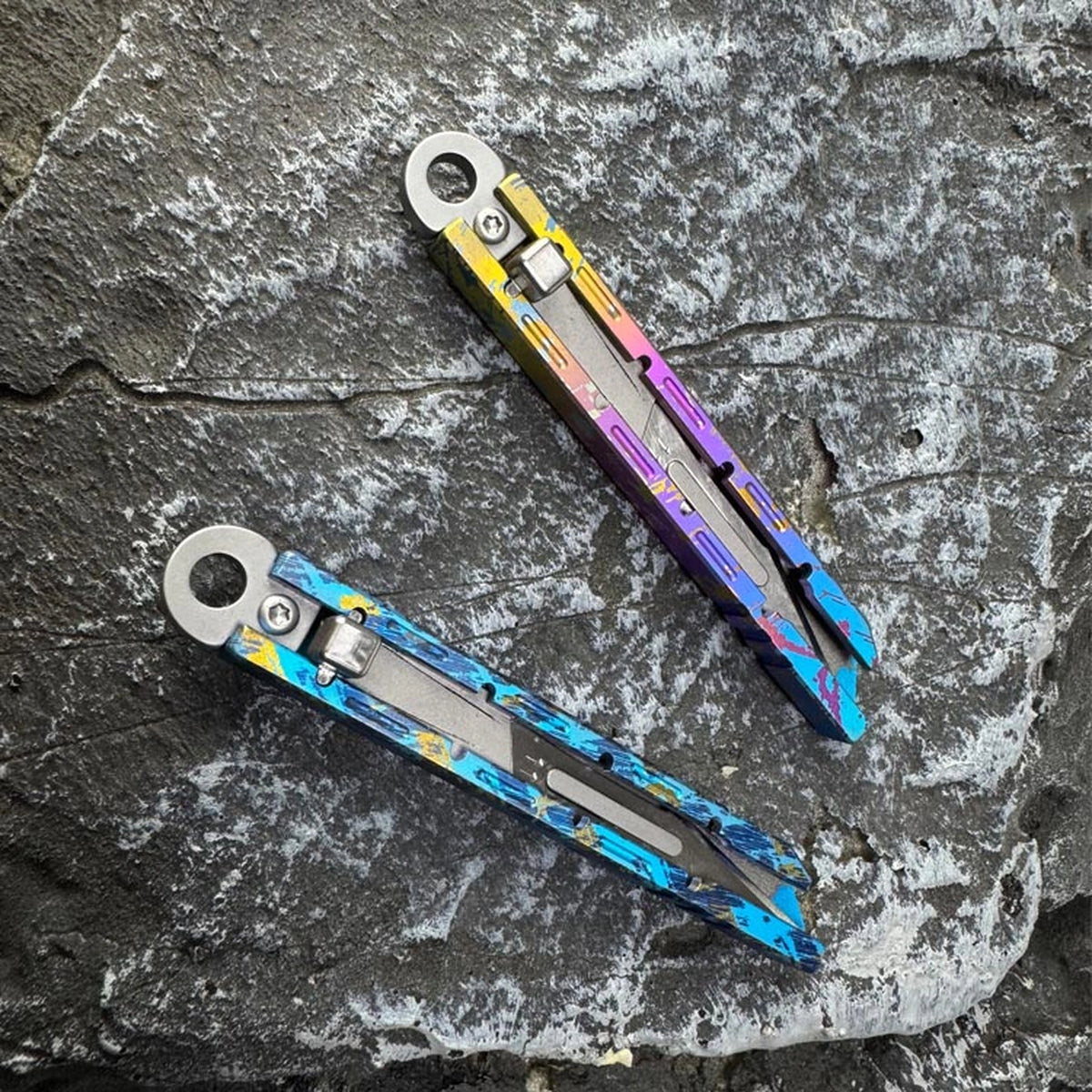Titanium Keychain Package Opener: two finish examples shown separately on stone (gallery view 04).