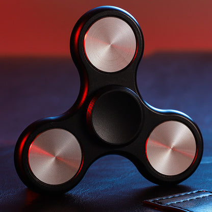 Black three-lobe spinner with silver-tone circular inlays and a black center grip.