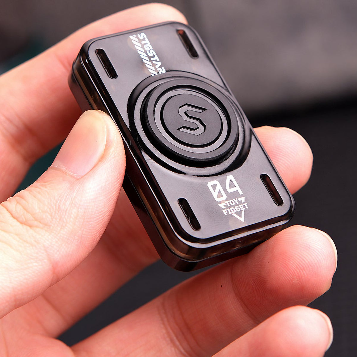 Black glow-tube slider and spinner held in one hand