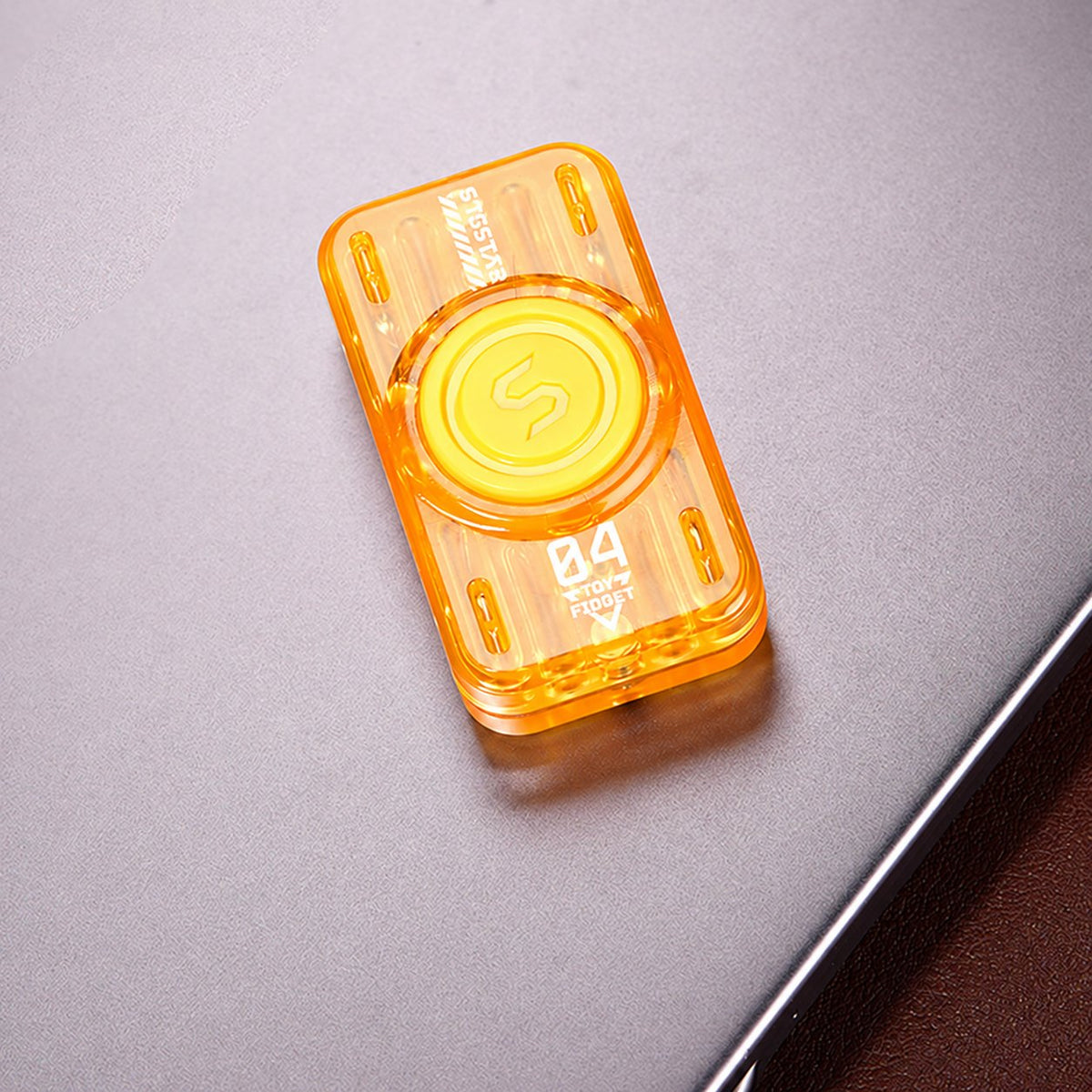 Yellow translucent glow-tube slider and spinner on a tabletop