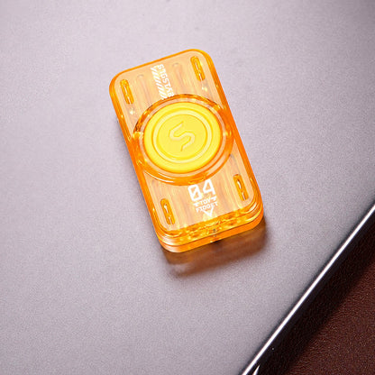 Yellow translucent glow-tube slider and spinner on a tabletop