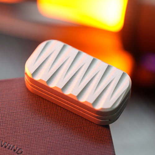 Matte silver three-layer rectangular slider with alternating sculpted grooves on its face.