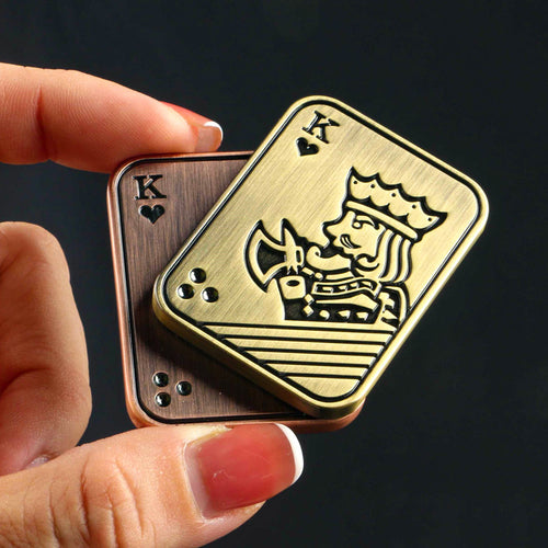 Antique-tone King of Hearts slider with its two decorated plates offset in a hand.