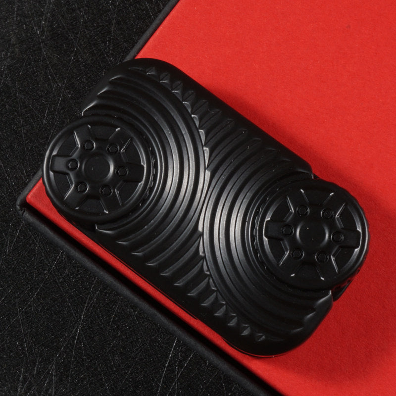 Black Star Wheel slider with two wheel-like face details and surrounding curved grooves.
