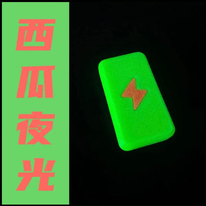Twin-Track rectangular fidget slider in watermelon glow with a textured lightning-bolt face.
