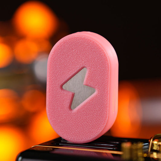 Aurora 2.0 / Cherry Blossom Pink fidget slider with a textured pill-shaped face and a lightning-bolt motif.