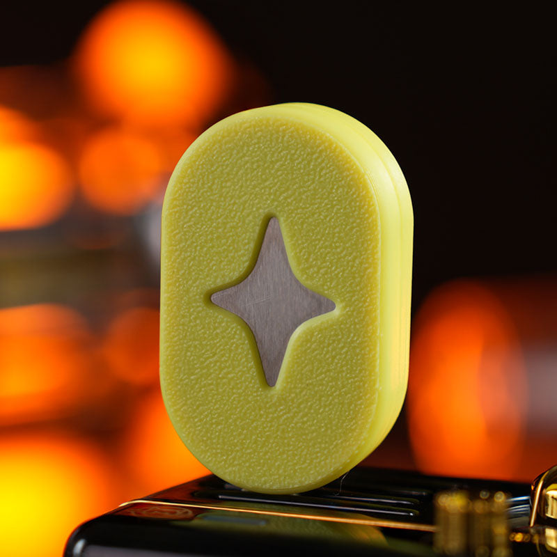 Polar Star / Pale Yellow fidget slider with a textured pill-shaped face and a four-point star motif.