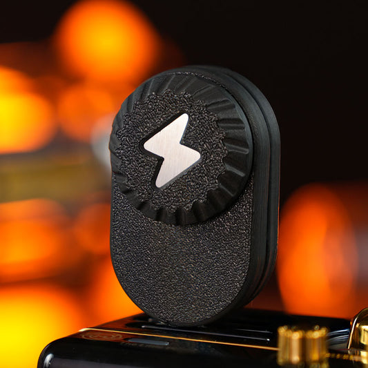 Aurora 2.0 Pro / Black fidget toy with a textured rounded body and ridged round dial featuring a lightning-bolt motif.
